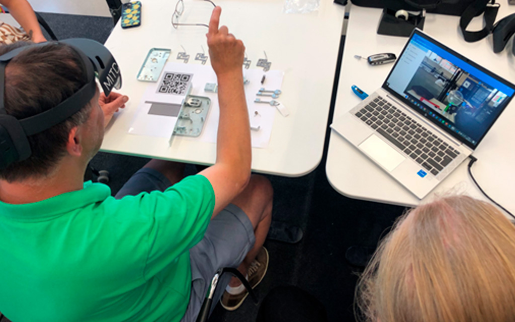 Worker using augmented reality headset to assist with lock assembly