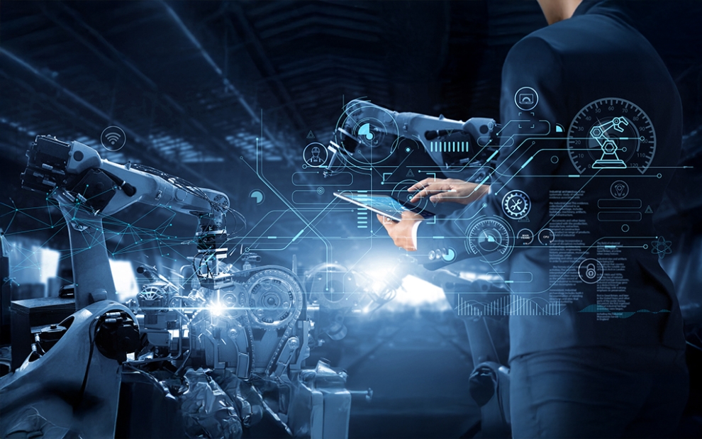Industry 5.0 smart factory with AI-driven robotic arms and digital control by engineer