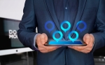 usinessman in a suit holding a tablet with digital location icons hovering above it, representing modern digital technology and connectivity